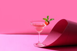 Fototapeta  - Glass of tasty cosmopolitan cocktail on color background