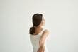 © SHOTPRIME STUDIO - woman in white t-shirt joint pain treatment health light background