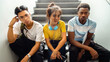 Portrait of multiracial group of teen high school students sitting on stairs looking at camera. Horizontal banner image.