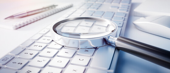 Magnifying glass on computer keyboard - search technology concept