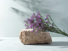 Natural Rough Gray Stone Podium Background With Purple Flowers, Shadows