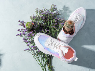 Canvas Print - White sneakers with sequins and purple flowers on turquoise background