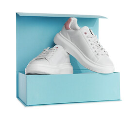 Wall Mural - Pair of stylish sport shoes and turquoise box on white background