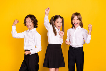 Sticker - Photo of three astonished schoolkids celebrate victory wear white shirt isolated yellow color background