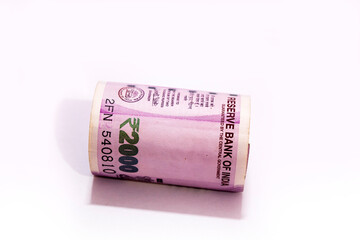 Sticker - Indian two thousand rupees rolled up banknote isolated on white background.