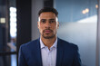 © Wavebreak Media - Portrait of mixed race businessman looking at camera