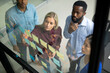 © Wavebreak Media - Diverse male and female business colleagues reading colourful memo notes on glass wall