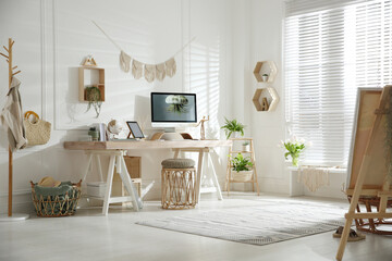 Sticker - Stylish home office interior with comfortable workplace and easel