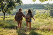 © master1305 - Close-up young man and woman, couple of lovers walking, strolling together outskirts of city, at summer forest. Active lifestyle, travel, meeting concept