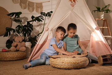 Poster - Cute little children with treasure map near toy wigwam at home