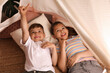 © New Africa - Cute little children lying in toy wigwam at home