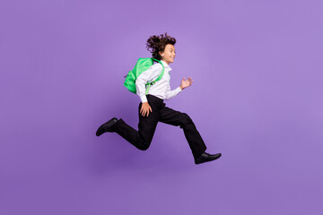 Sticker - Full size photo of cool little brunet boy run wear bag shirt trousers sneakers isolated on purple background