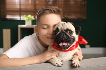 Wall Mural - Little boy with cute pug dog at home