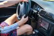 © Serhii - Prosthetic amputated hand of a Caucasian man on the steering wheel who drives a car on a sunny summer day