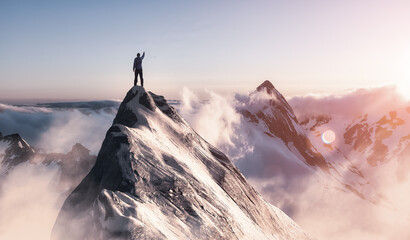 Wall Mural - Adventure Composite. Adventurous Man is taking in the moment on top of a mountain. CGI Rocky Peak. Colorful Sunset or Sunrise Sky. Aerial Background Landscape from British Columbia, Canada.