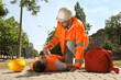 © New Africa - Worker with bottle of water helping colleague on city street. Suffering from heat stroke