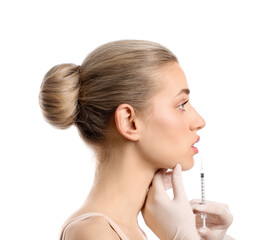 Canvas Print - Young woman receiving filler injection in lips against white background