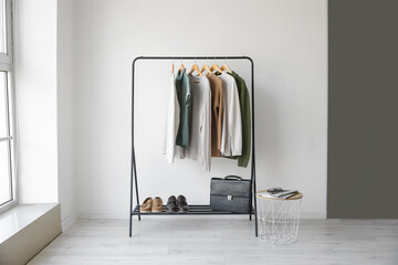 Wall Mural - Rack with stylish clothes in room
