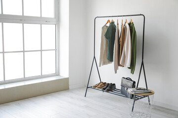 Wall Mural - Rack with stylish clothes in room