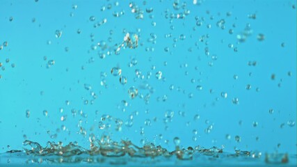 Poster - Super slow motion water droplets fall on a blue background. Filmed on a high-speed camera at 1000 fps.High quality FullHD footage