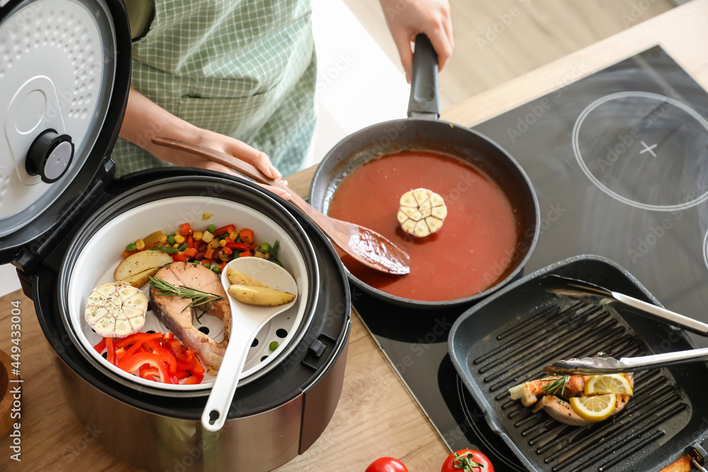 Woman cooking dinner in kitchen
