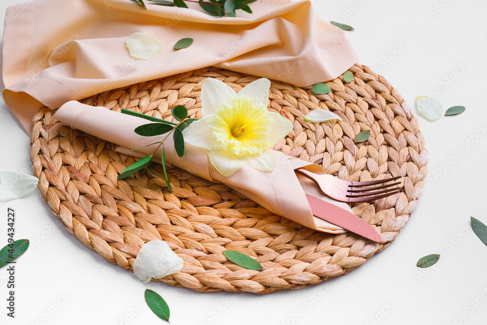 Beautiful table setting with narcissus flower on white background