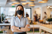 Woman Business Owner Wearing Face Mask After Reopening Restaurant, Arms Folded