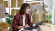 © ChayTee - Young asia seller woman happy work on laptop busy cellphone call chat to customer at home office desk use digital tablet computer in SME online store social e-commerce sale page service web support.