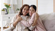 © ChayTee - Attractive beautiful mum sit at cozy sofa couch living room in family moment grown up child kid look camera celebrate joy good warm time relationship with retired overjoy lady girl life insurance.