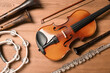© New Africa - Set of different musical instruments on wooden background, flat lay