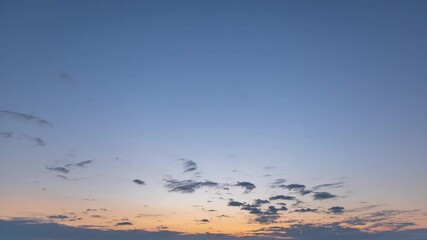 Wall Mural - morning sunrise 4k stock video time lapse of gradient blue and orange sky with soft small clouds mov