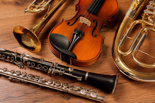 set of different musical instruments on wooden background, closeup
