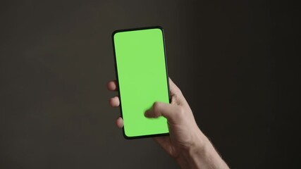 Sticker - POV top view shot of man using phone with green screen indoor