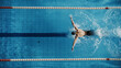 Leinwandbild Motiv Aerial Top View Male Swimmer Swimming in Swimming Pool. Professional Determined Athlete Training for the Championship, using Butterfly Technique. Top View Shot