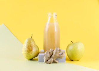 Wall Mural - a bottle of pear juice with ginger on a colored background