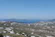 panoramic White and blue top of buildings in Pyrgos Santorini, Greece with blue sky in a sunny warm day in July 2021.