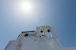 two bells  on a buildings in Pyrgos Santorini, Greece with blue sky in a sunny warm day in July 2021.