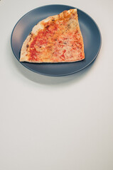 Wall Mural - Plate with a slice of pizza isolated on a white background- free space for text