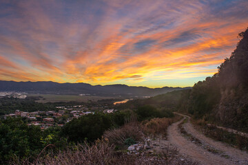 Algeria jijel, picture from mountain of a small village with sunrise in state of Jijel, Algeria, a road and a river in middle of a rural village far from Algiers, 350 m east near Mediterranean sea.