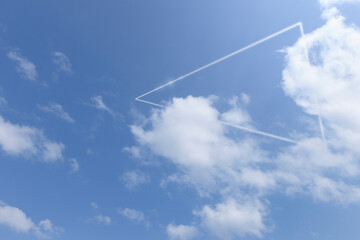 White triangle glowing around the clouds against blue sky. Abstract natural background.