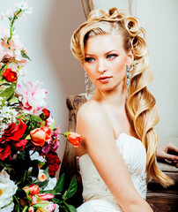 beauty emotional blond bride in luxury interior dreaming, crazy complicate hairstyle, many flowers