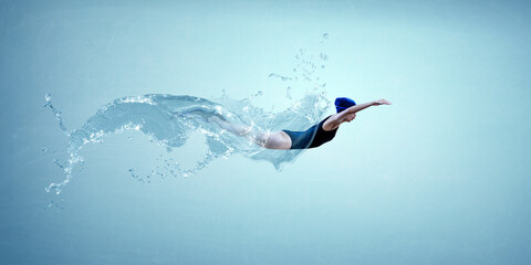 Poster - Professional woman swimmer on a wave