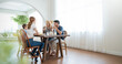 © paulaphoto - Portrait of caucasian hispanic family couple child having breakfast morning at dinning table. Happy modern white family. People family love together lifestyle indoors concept banner