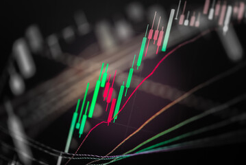 Abstract financial trading graphs and digital number of foreign exchange market trading on monitor. Background of gold and blue digital chart to represent stock market trend.