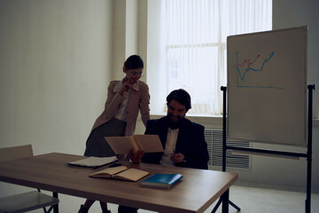 Wall Mural - business man and woman sitting at work desk office team communication