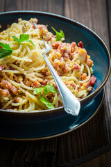 Spaghetti Carborana made of becon and eggs. Italian classic dinner.