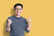 © whyframeshot - success exited asian attractive male cheerful hand rise up,smart asian glasses man big surprice action pose white background