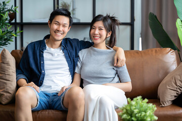 home isolation concept happiness asian love couple familygood conversation on sofa couch in living room ,marry couple laugh smile together on sofa