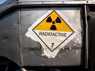 Wall Mural - Radiation warning sign on the Dangerous goods transport label Class 7 at the side transport truck