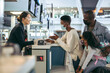 © Jacob Lund - African family at airport check-in desk with face masks